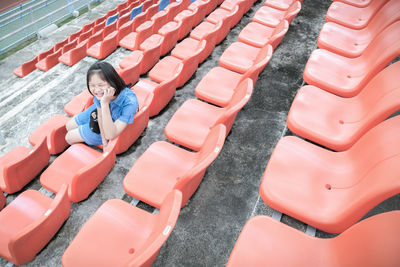 High angle view of people sitting on chair