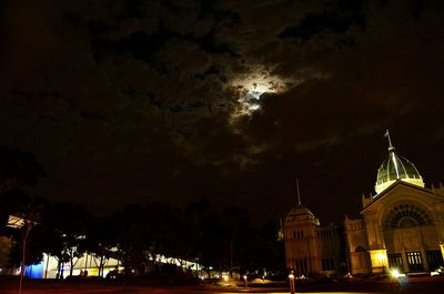 Illuminated buildings against sky at night