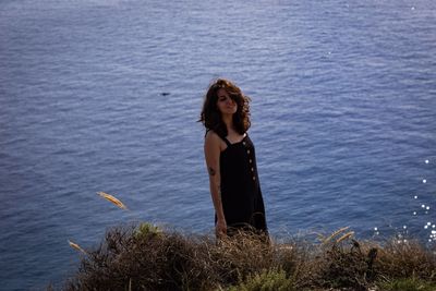 Young woman standing in sea