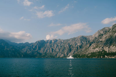 Scenic view of sea and mountains against sky