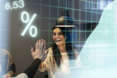 Businesswomen high fiving in office