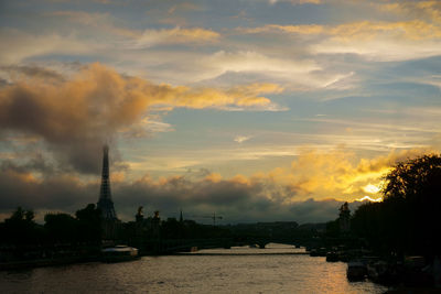 Clouds over eiffel tower and seine river in paris