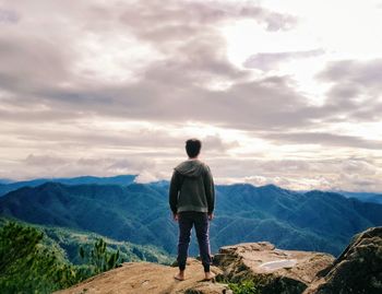 Rear view of man standing on mountain