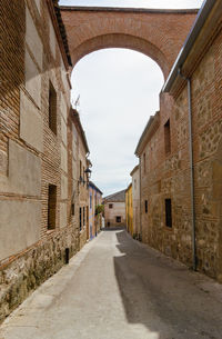 Empty road along buildings