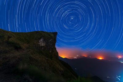 Scenic view of mountains against sky at night