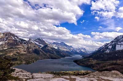 Scenic view of snowcapped mountains and lake against cloudy sky