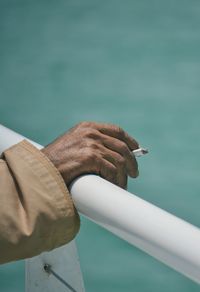 Close-up of man holding cigarette