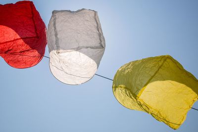 Low angle view of paper lantern hanging against clear sky