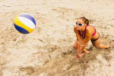 High angle view of woman playing beach volleyball