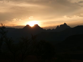 Scenic view of silhouette mountains against sky during sunset