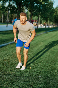 Full length of young man sitting on grass