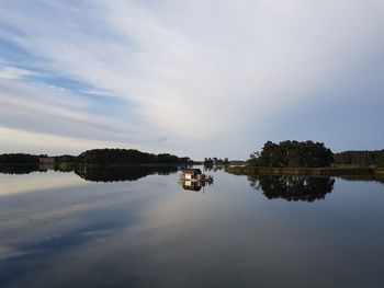 Reflection of trees in lake against sky