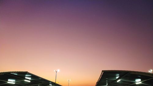 Low angle view of illuminated building against sky at night