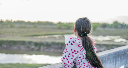 A young woman contemplates life as she drinks coffee.