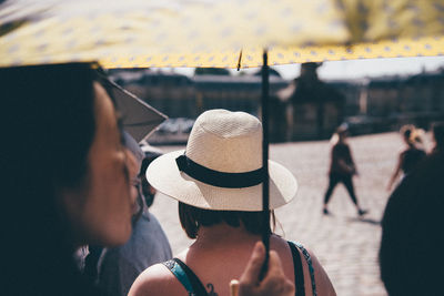 Rear view of woman wearing hat in city