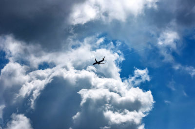 Low angle view of airplane flying in sky