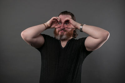 Portrait of man wearing mask against gray background