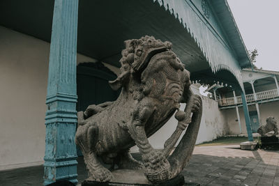 Statue of horse by building