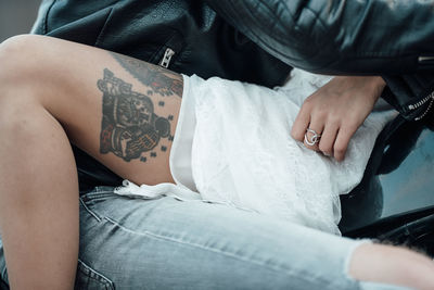 Midsection of man with woman sitting at home