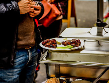 Midsection of man holding food