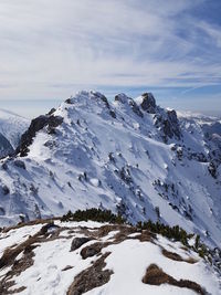 Scenic view of snow covered mountains against sky