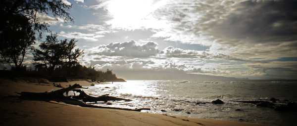 Scenic view of beach against sky during sunset