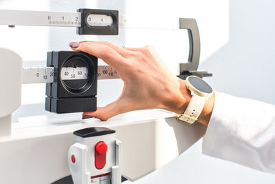 Nutritionist with his hands on the scales in his practice