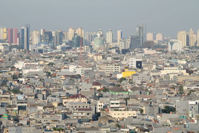 High angle view of buildings in city against clear sky