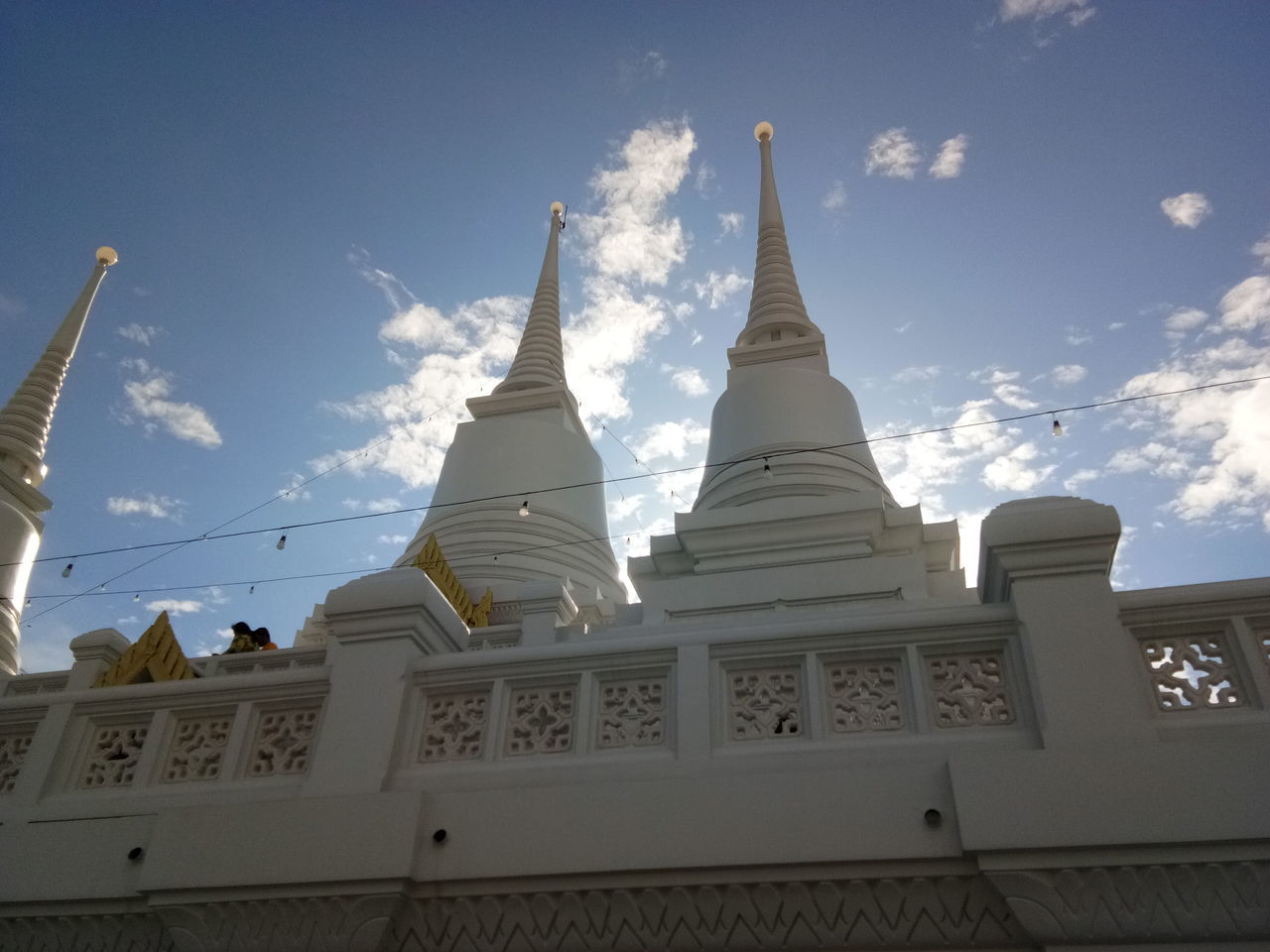 LOW ANGLE VIEW OF TEMPLE AGAINST BUILDING AND SKY