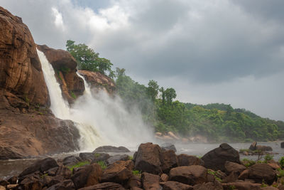 Waterfall with cloudy sky and green forests of the western ghat range