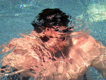 Close-up of young woman in swimming pool