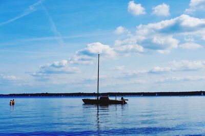 Boats sailing in calm sea against sky