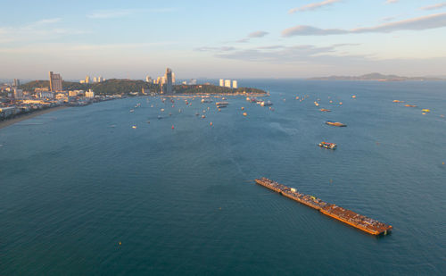 High angle view of sea by cityscape against sky