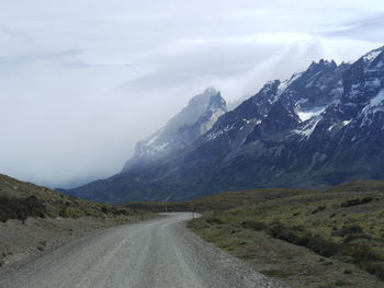 Country road by mountains of torres del paine national park against sky