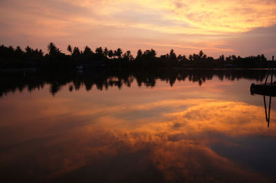 Scenic view of lake against romantic sky at sunset