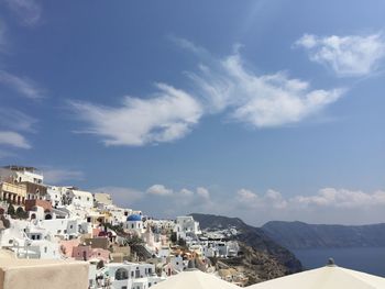 View of cityscape against cloudy sky