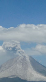 Smoke emitting from mount sinabung against sky