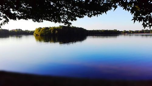 Scenic view of lake against sky at sunset