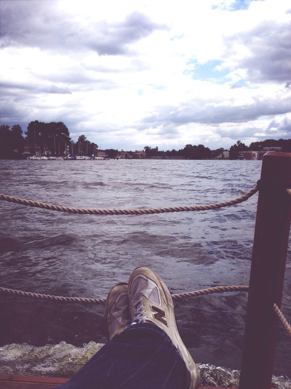 water, sky, cloud - sky, low section, person, personal perspective, sea, lake, scenics, shoe, tranquility, tranquil scene, lifestyles, cloud, nature, cloudy, pier, beauty in nature