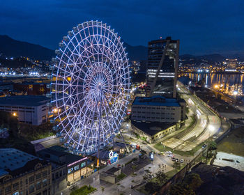 High angle view of illuminated ferris wheel at night