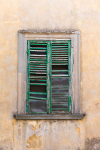 Closed weathered window of old building