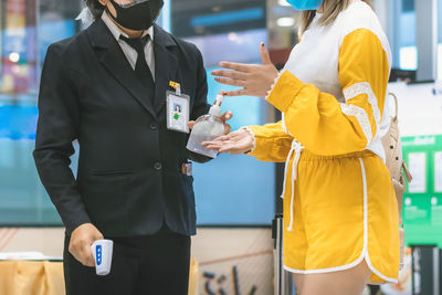 Rear view of people standing in bus