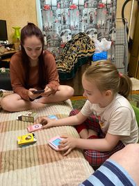High angle view of siblings playing on table