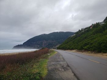 Road amidst plants against sky