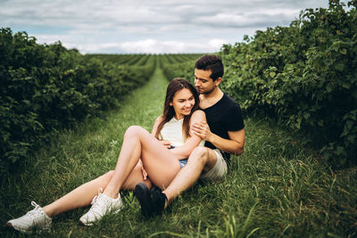 Young couple sitting on land