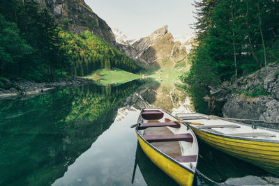 Boats moored on calm lake