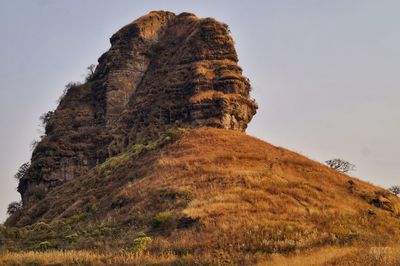 Low angle view of rock formation against sky