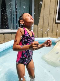 Cute girl playing in swimming pool