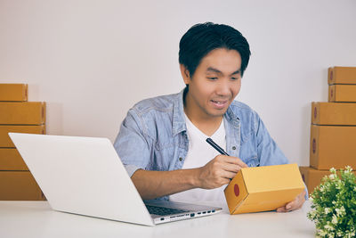 Man looking away while sitting on table