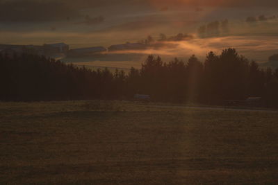 Scenic view of field against sky during sunset